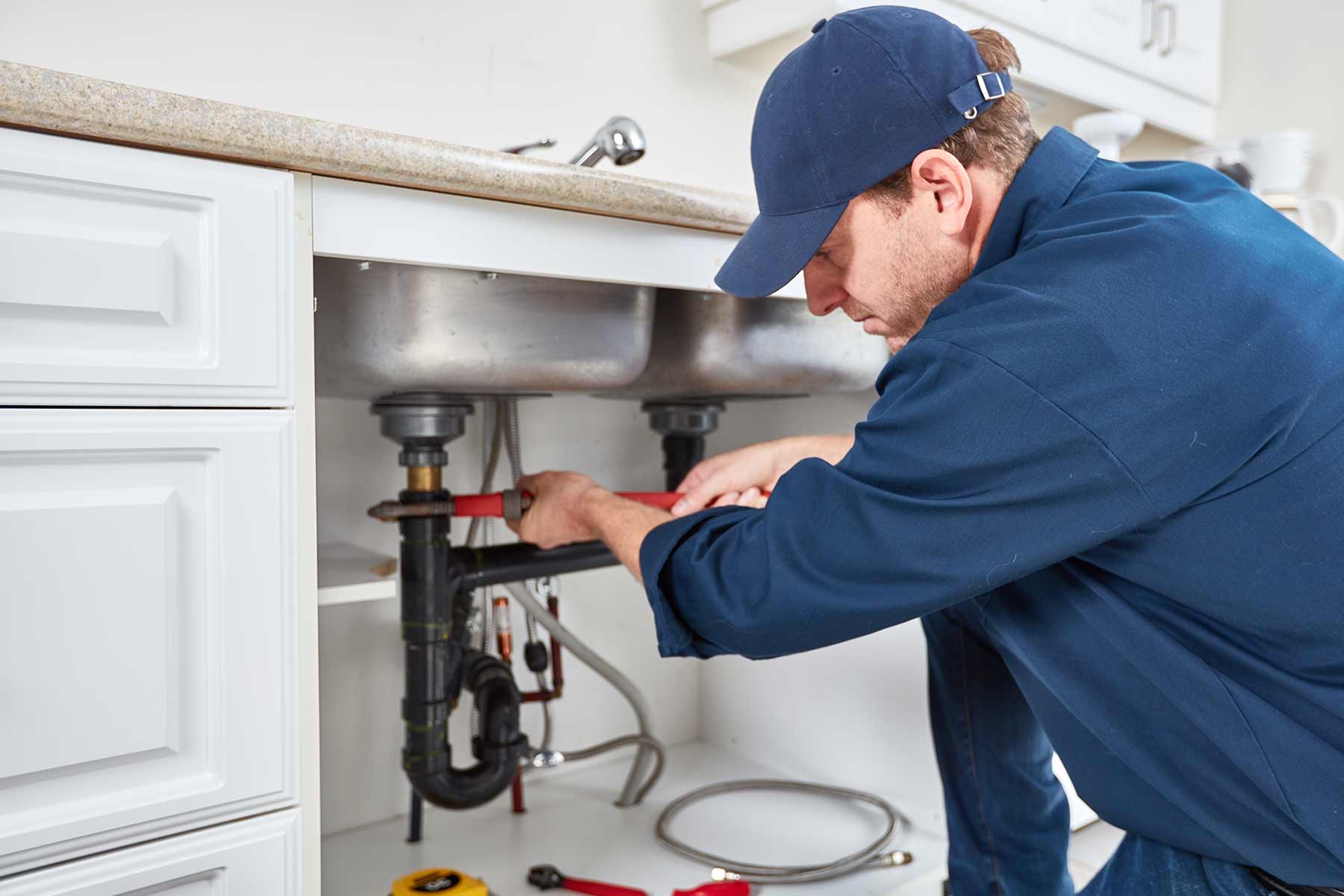 homeguide plumber sink repair cost plumber fixing kitchen sink pipe (1)